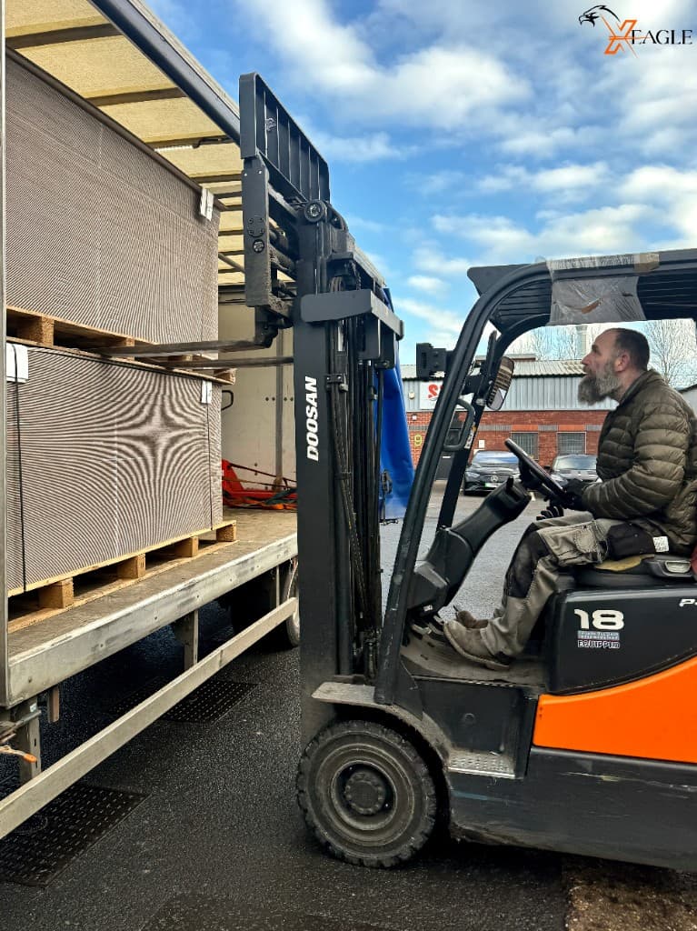 Forklift handling palletised cargo for courier delivery