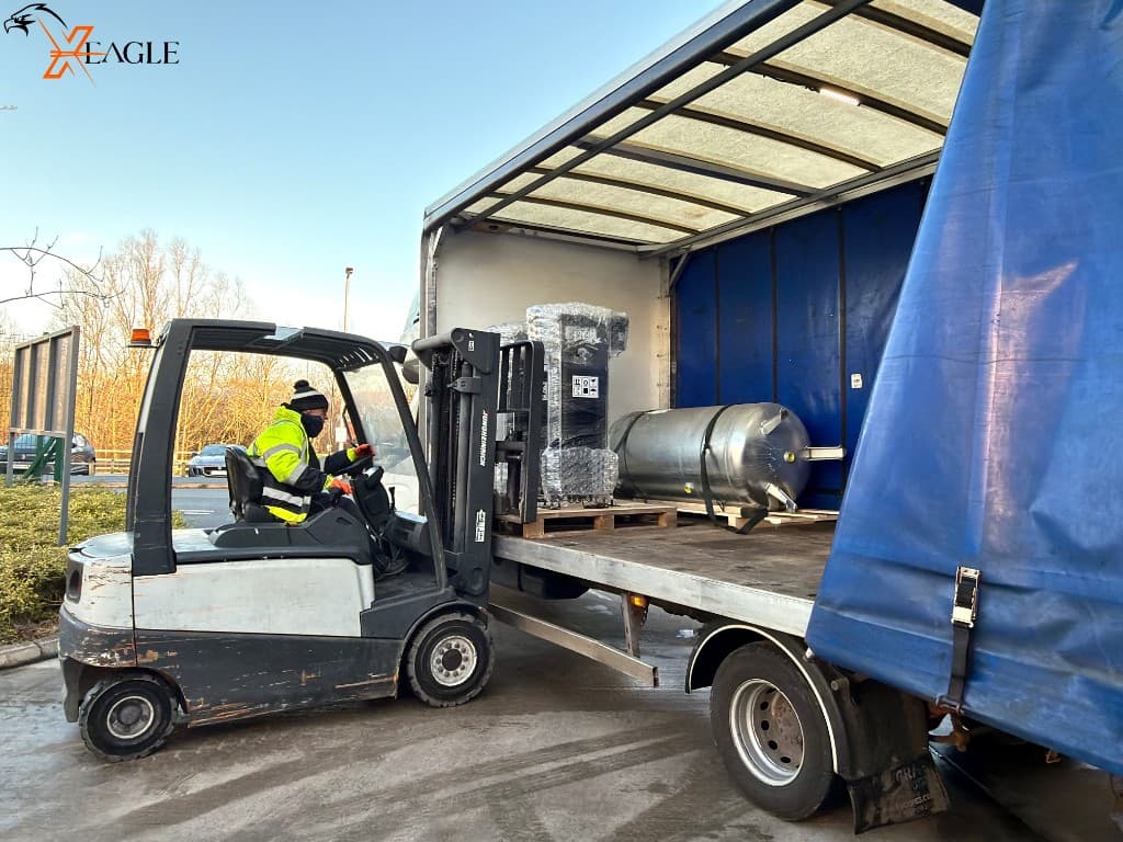 Loading industrial tank onto flatbed truck