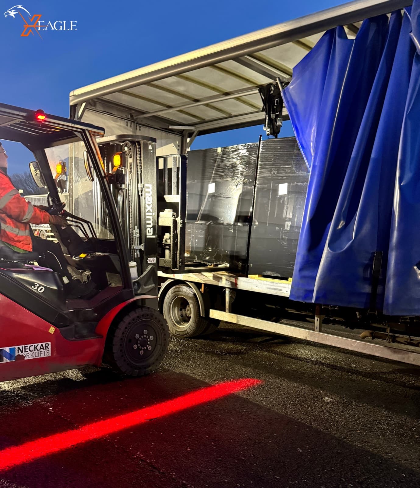 X-Eagle night-time forklift loading heavy cargo