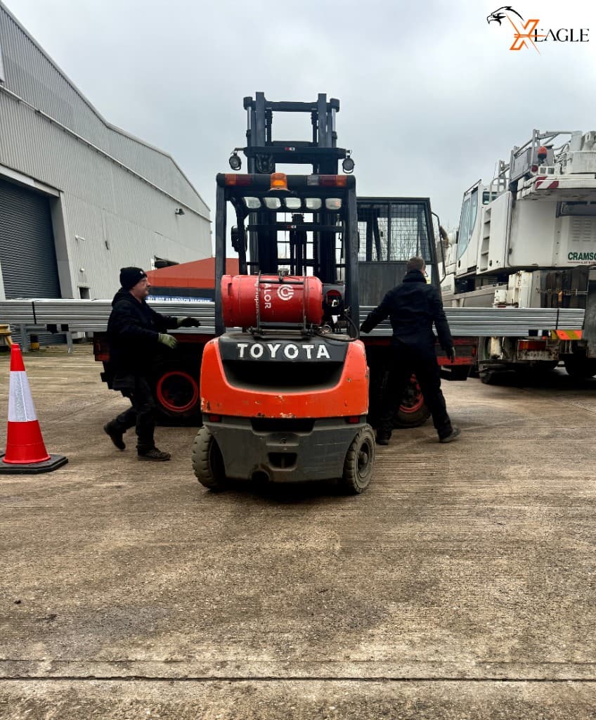 Two-man courier team loading with forklift